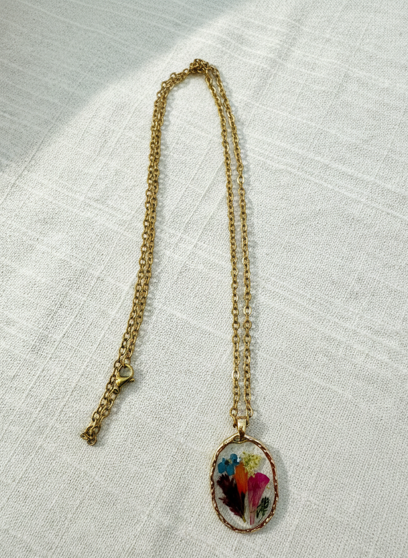 Necklace with a colorful pendant on a textured white fabric background