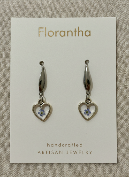 Heart-shaped earrings on a Florantha branded card