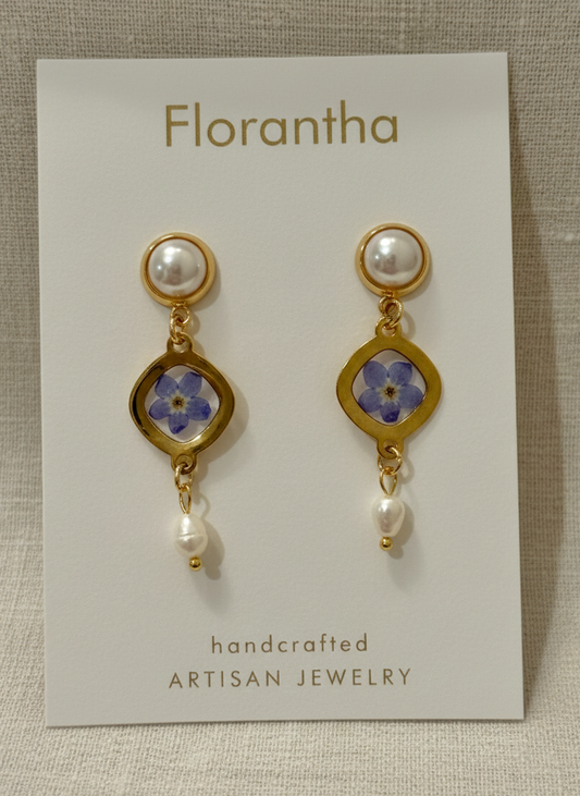 Florantha earrings on a display card with floral design and pearl accents.