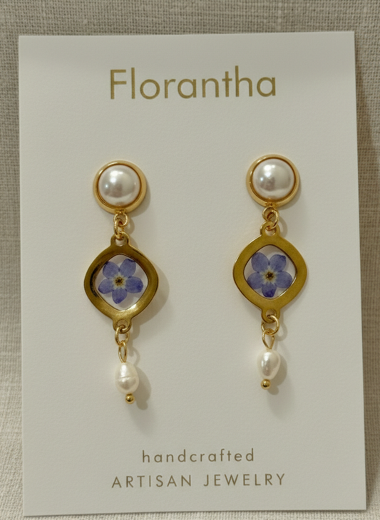 Pair of earrings with floral design on a 'Florantha' card