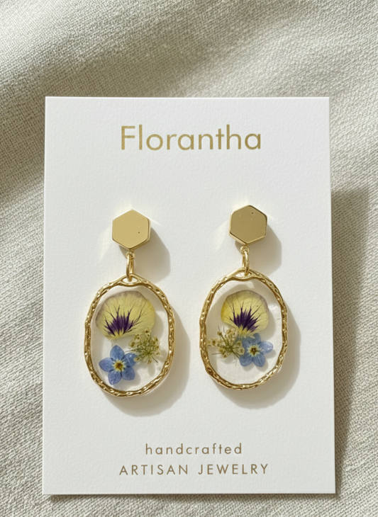 Florantha earrings with floral design on a white card