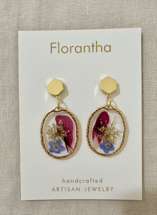 Florantha earrings on a branded card with a textured background