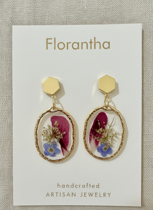Florantha earrings with floral details on a branded card.