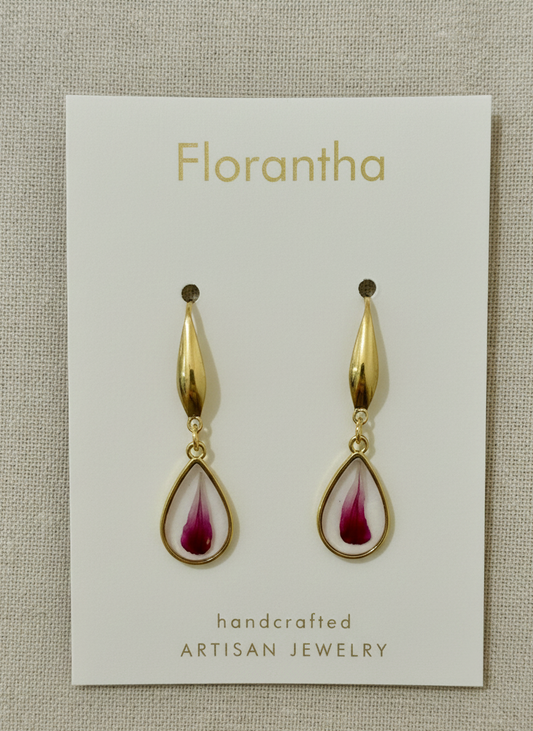 Florantha earrings on a branded card with a textured beige background