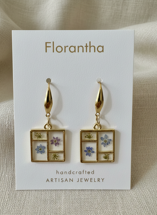Florantha earrings on a branded card with a beige background